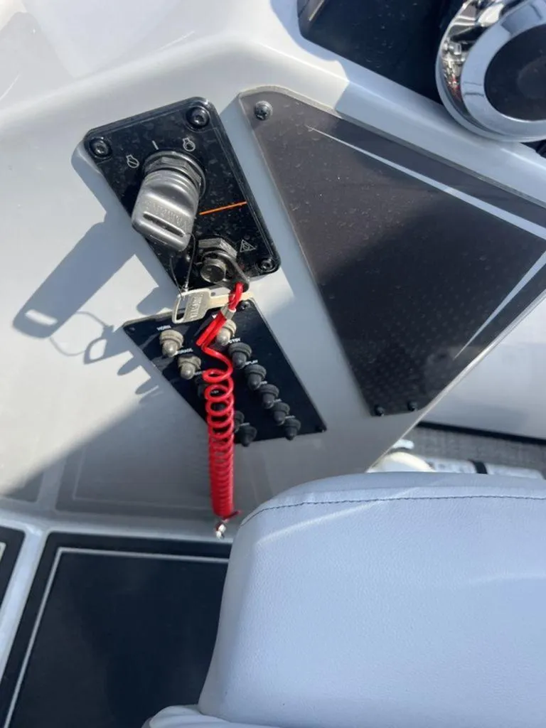 Slide: The Image of Control panel of 2025 SunCatcher Fusion 322 FC boat with red safety lanyard. - 42