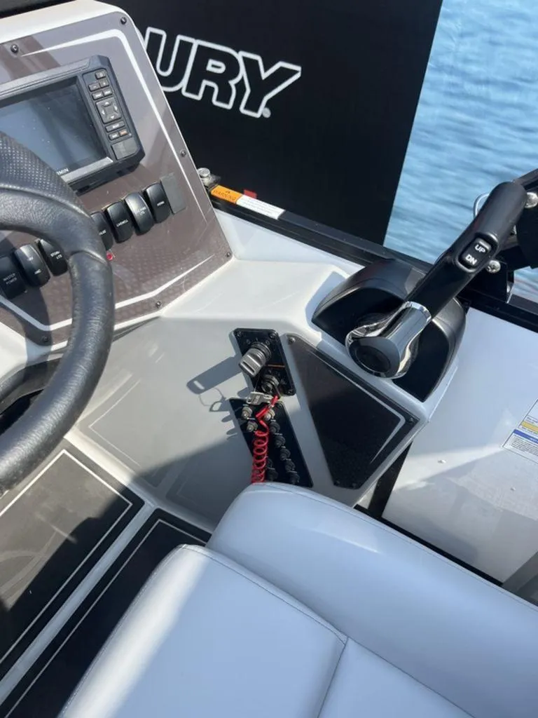 Slide: The Image of 2025 SunCatcher Fusion 322 FC boat dashboard with steering wheel and controls. - 43