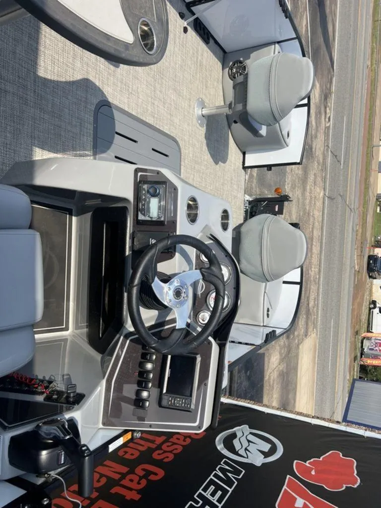 Slide: The Image of 2025 SunCatcher Fusion 322 FC boat interior with steering wheel and seating. - 44