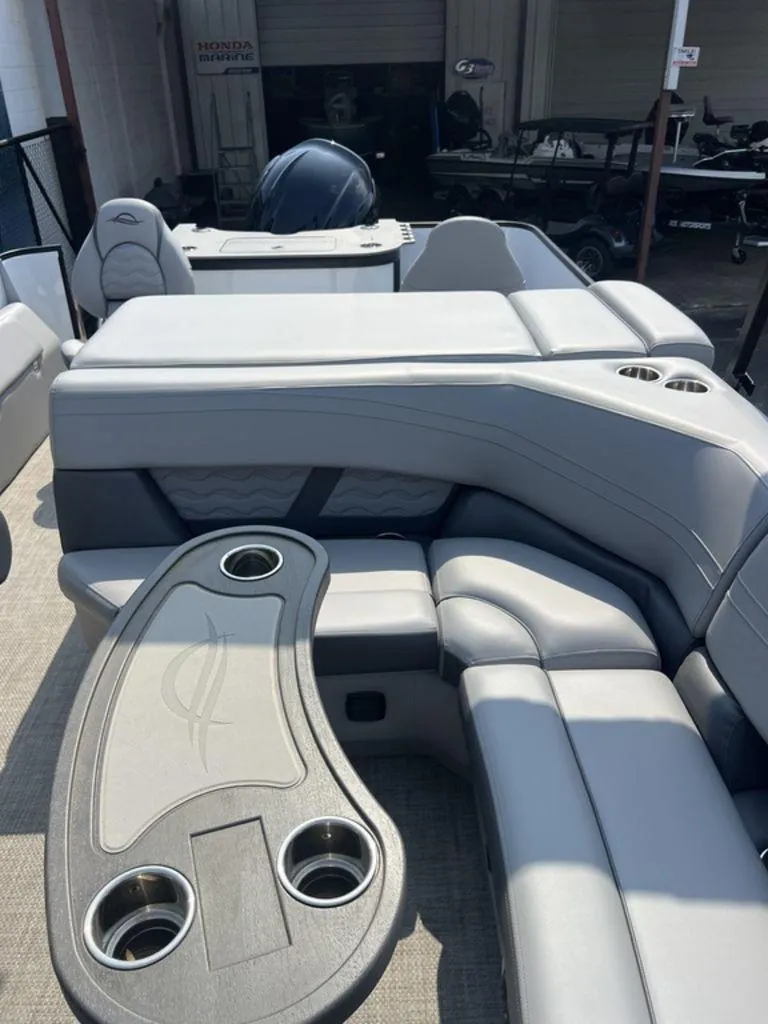 Slide: The Image of 2025 SunCatcher Fusion 322 FC boat interior with gray seating and cup holders. - 46