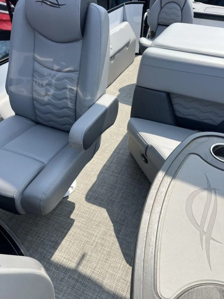 Slide: The Image of 2025 SunCatcher Fusion 322 FC boat interior with gray seating and table. - 48
