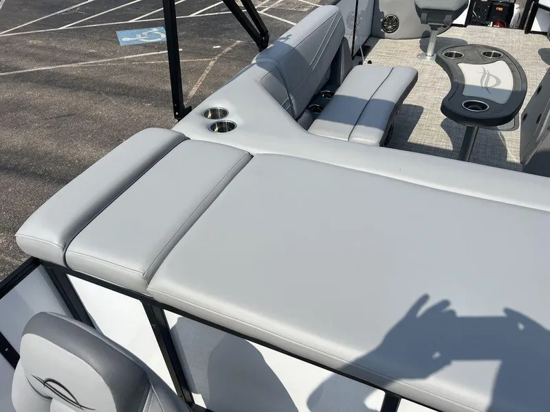 Slide: The Image of 2025 SunCatcher Fusion 322 FC boat interior with gray seating and cup holders. - 49