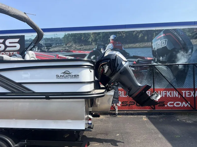 Slide: The Image of 2025 SunCatcher Fusion 322 FC boat with powerful outboard motor, displayed outdoors. - 5