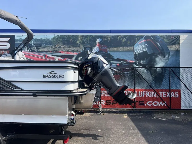 Slide: The Image of 2025 SunCatcher Fusion 322 FC boat with powerful outboard motor, displayed outdoors. - 6