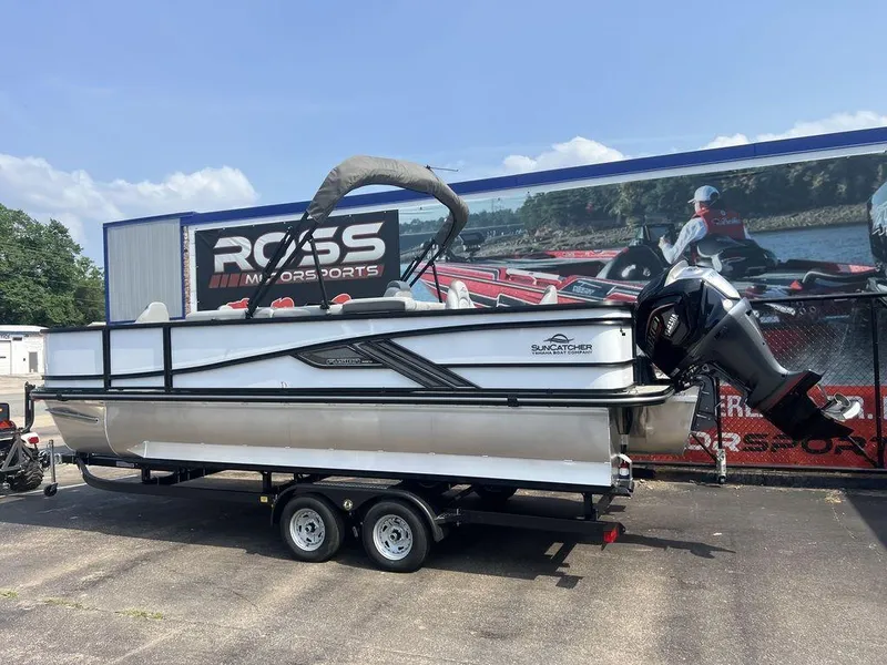 Slide: The Image of 2025 SunCatcher Fusion 322 FC pontoon boat on trailer at Ross Motorsports dealership. - 8