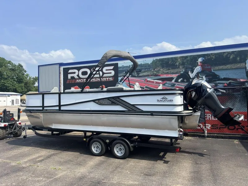 Slide: The Image of 2025 SunCatcher Fusion 322 FC pontoon boat on trailer at dealership. - 9