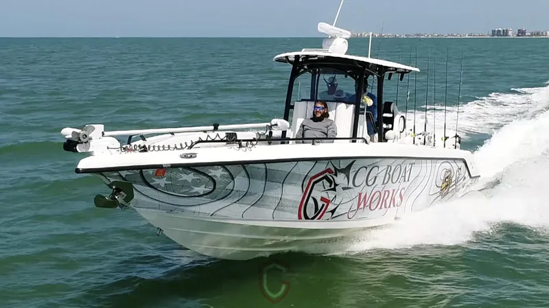 Slide: The Image of 2022 CG Boat Works 35 M-Series cruising on open water, showcasing sleek design and performance. - 2