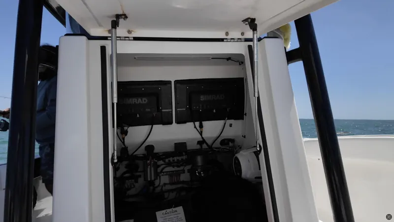 Slide: The Image of 2022 CG Boat Works 35 M-Series dashboard with dual Simrad displays on open water. - 23