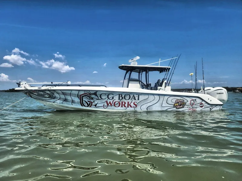 Slide: The Image of 2022 CG Boat Works 35 M-Series on calm water under a clear blue sky. - 3