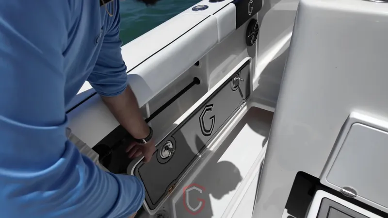 Slide: The Image of Person adjusting storage compartment on 2022 CG Boat Works 35 M-Series. - 36