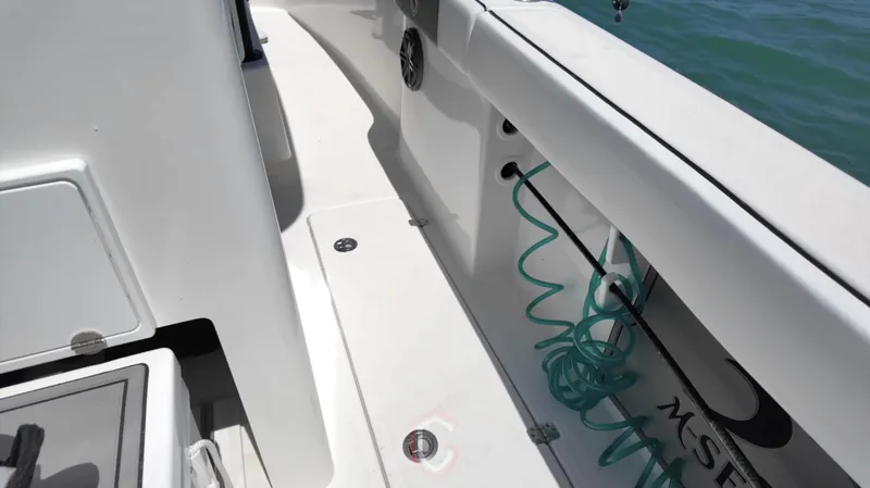 Slide: The Image of 2022 CG Boat Works 35 M-Series deck with coiled hose and storage compartments. - 37