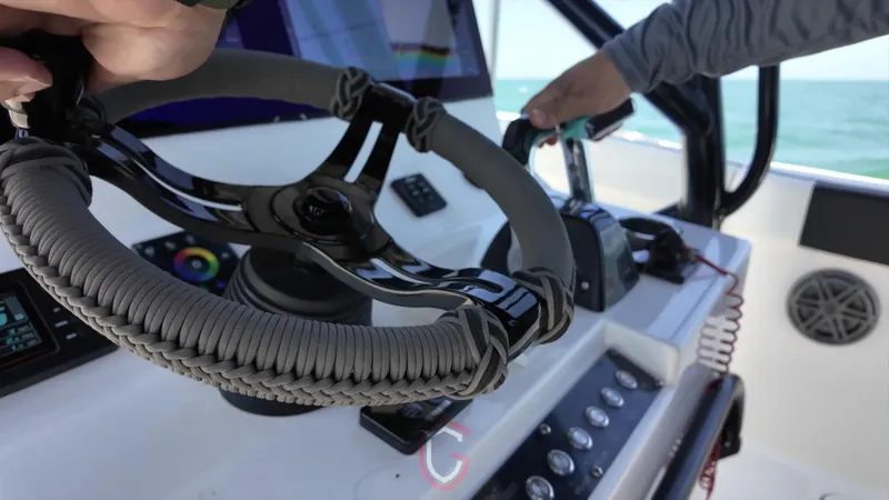 Slide: The Image of Steering wheel and controls of 2022 CG Boat Works 35 M-Series on open water. - 38