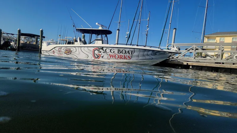 Slide: The Image of 2022 CG Boat Works 35 M-Series docked at marina, reflecting on calm water. - 4