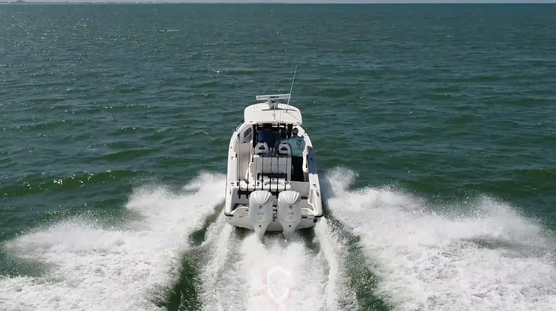 Slide: The Image of 2022 CG Boat Works 35 M-Series cruising on open water, rear view. - 46