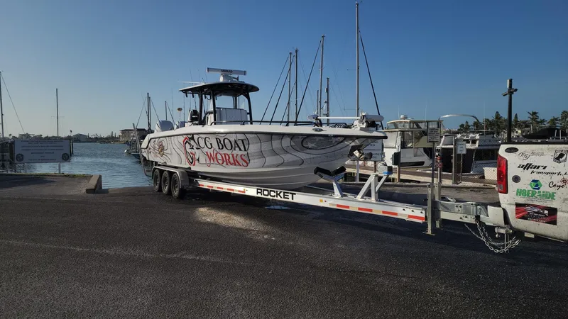 Slide: The Image of 2022 CG Boat Works 35 M-Series on trailer at marina dock. - 47