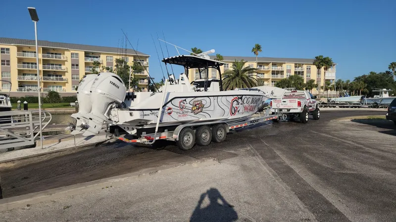 Slide: The Image of 2022 CG Boat Works 35 M-Series on trailer, parked near waterfront buildings. - 49