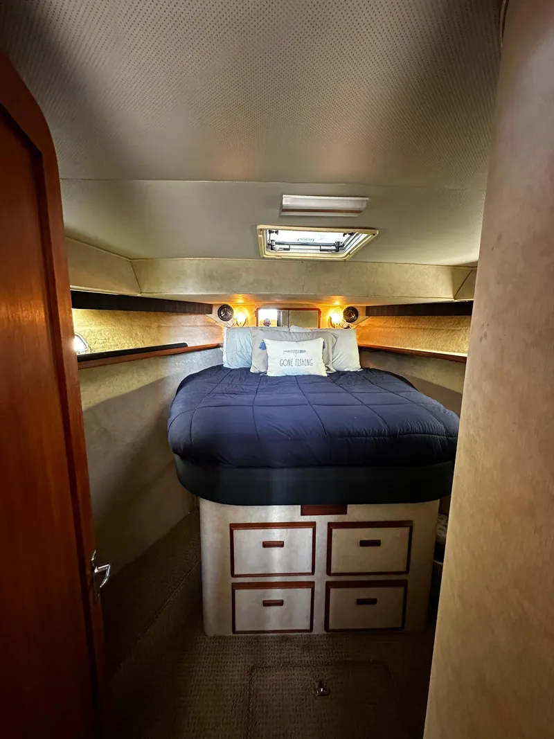 Slide: The Image of 1985 Chris-Craft 382 Commander cabin with cozy bed and storage drawers. - 11