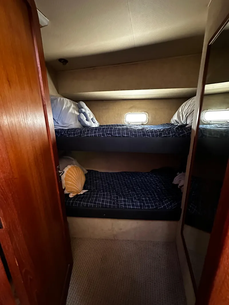 Slide: The Image of 1985 Chris-Craft 382 Commander cabin with bunk beds and wooden interior. - 12