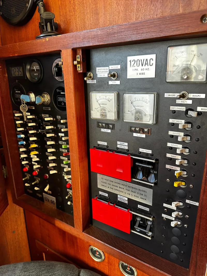 Slide: The Image of Electrical panel of a 1985 Chris-Craft 382 Commander boat, featuring gauges and switches. - 17