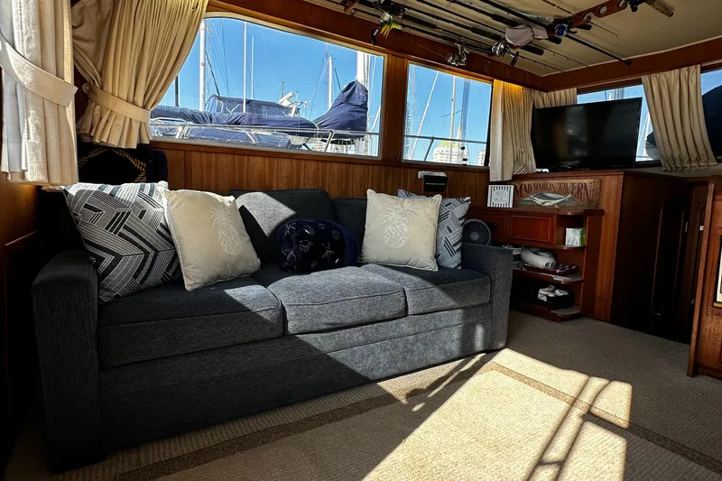 Slide: The Image of Interior of 1985 Chris-Craft 382 Commander with sofa, pillows, and nautical decor. - 19