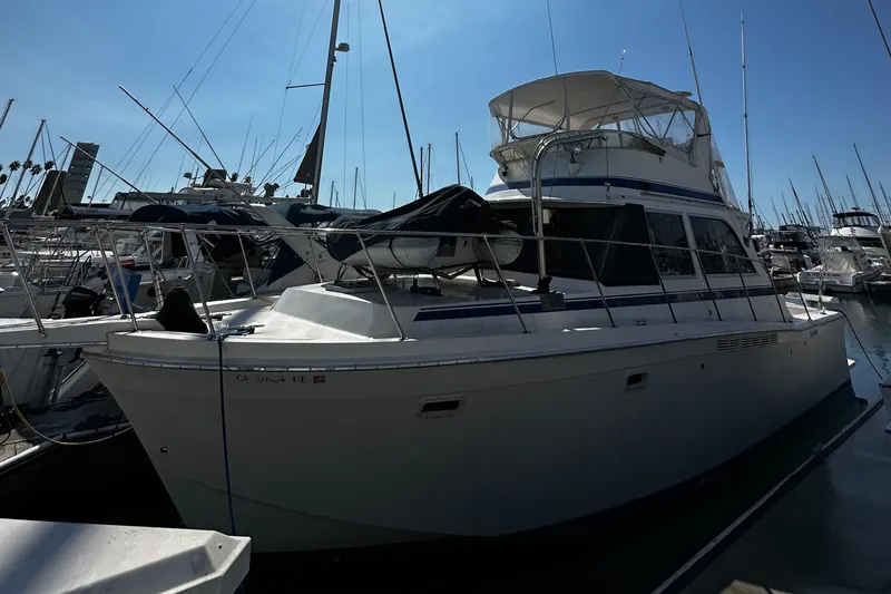 Slide: The Image of 1985 Chris-Craft 382 Commander yacht docked in marina, surrounded by other boats. - 2