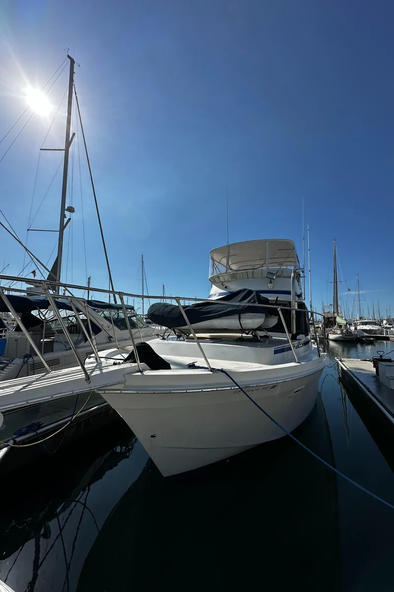 Slide: The Image of 1985 Chris-Craft 382 Commander yacht docked under clear blue sky. - 4
