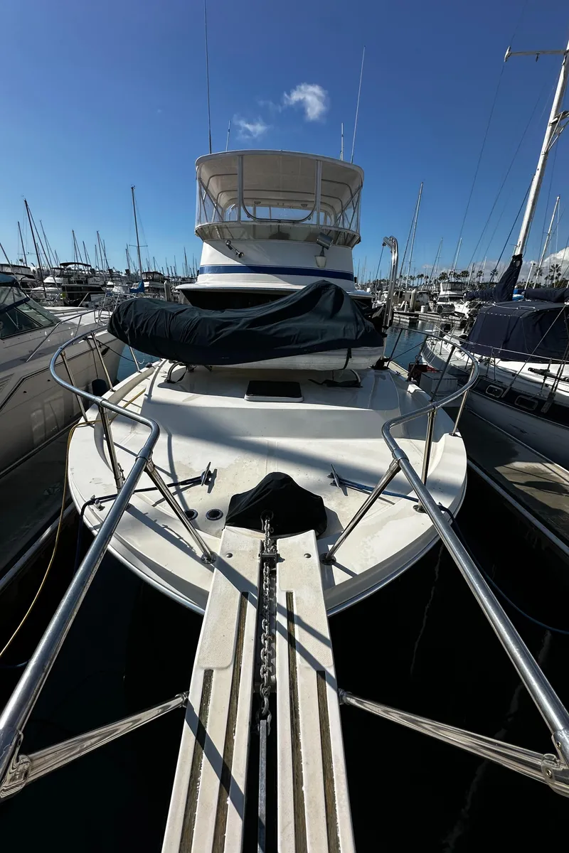 Slide: The Image of 1985 Chris-Craft 382 Commander yacht docked in marina under clear blue sky. - 6
