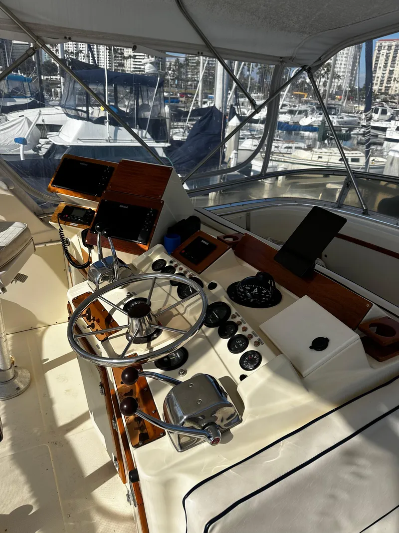 Slide: The Image of 1985 Chris-Craft 382 Commander yacht cockpit with steering wheel and control panel. - 9