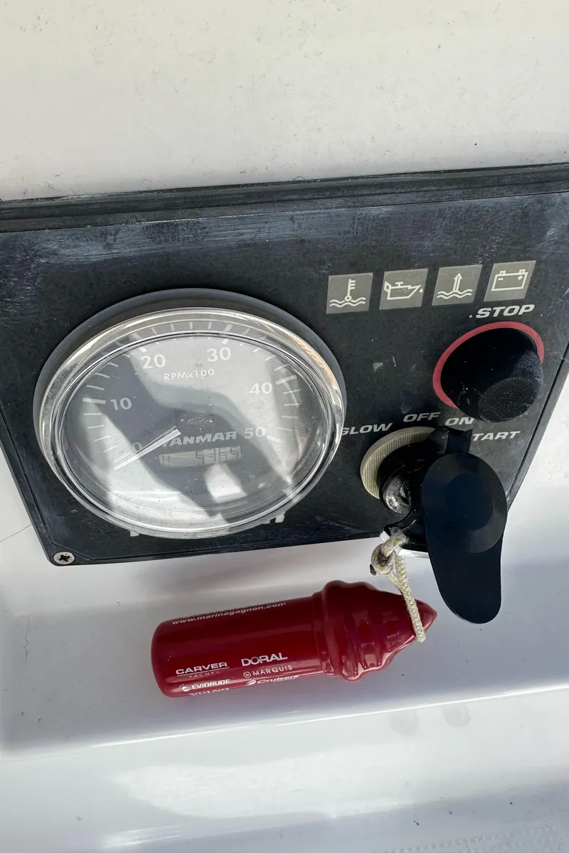 Slide: The Image of Control panel of a 2005 Beneteau First 44.7 sailboat with key and gauge. - 13