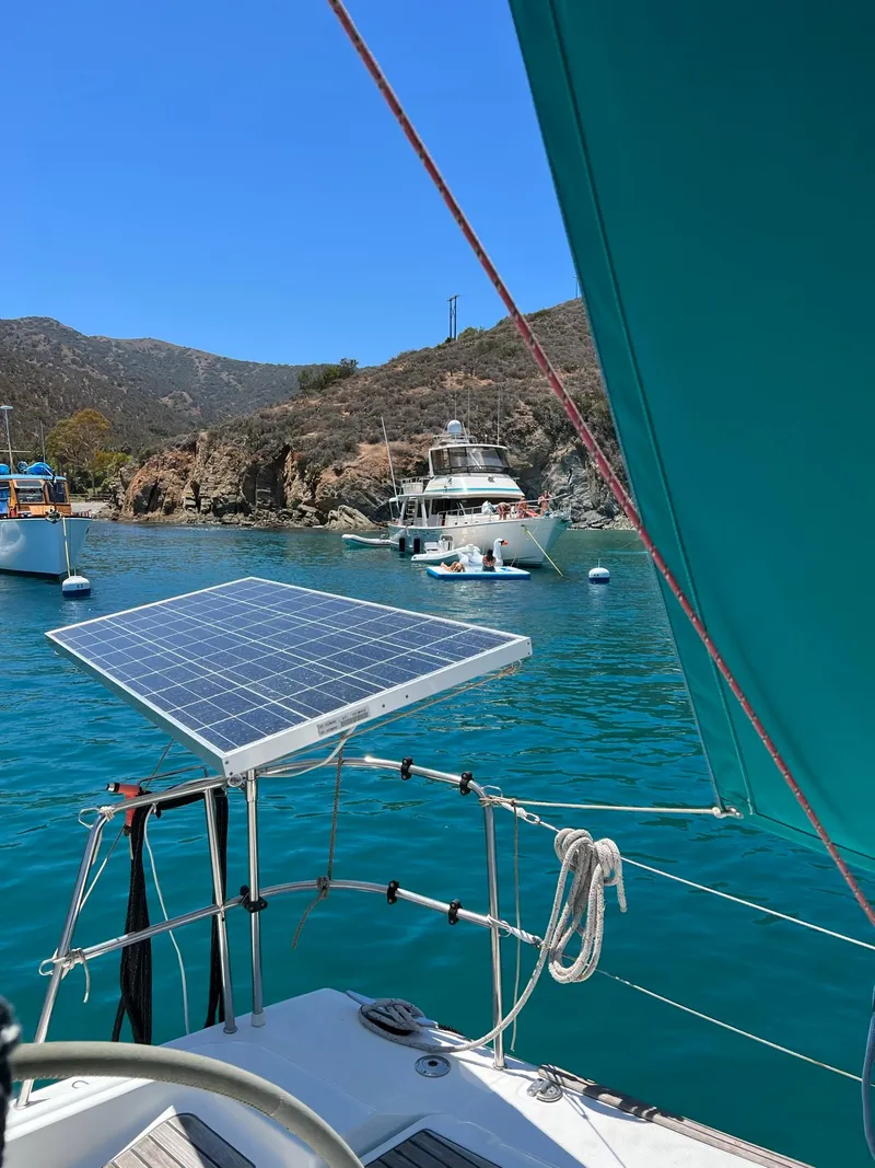 Slide: The Image of Beneteau First 44.7 sailboat with solar panel, anchored in scenic bay, 2005 model. - 15