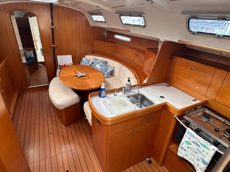 Slide: The Image of Interior of 2005 Beneteau First 44.7 yacht with wood finish and cozy seating area. - 17