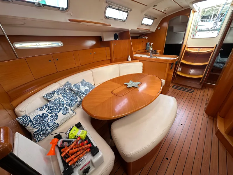 Slide: The Image of Interior of 2005 Beneteau First 44.7 yacht with wooden finish and cozy seating area. - 18