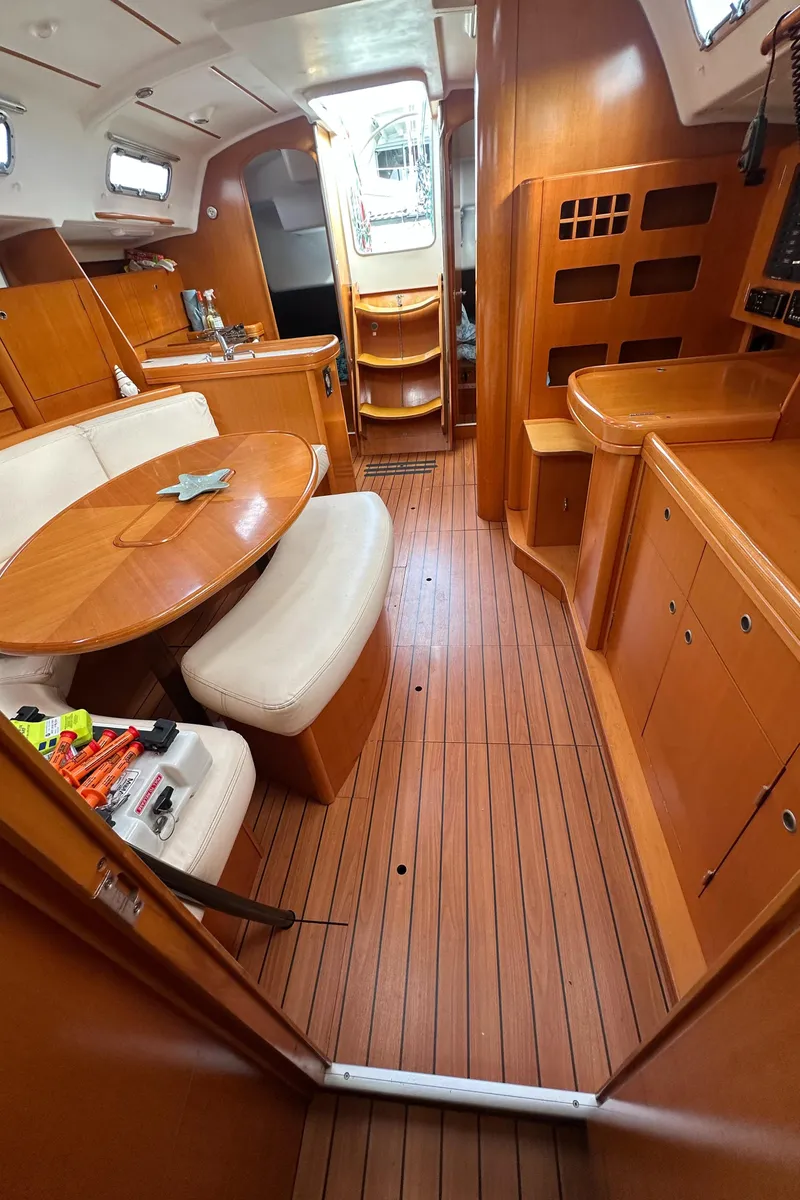 Slide: The Image of Interior of 2005 Beneteau First 44.7 sailboat with wood finish and seating area. - 19
