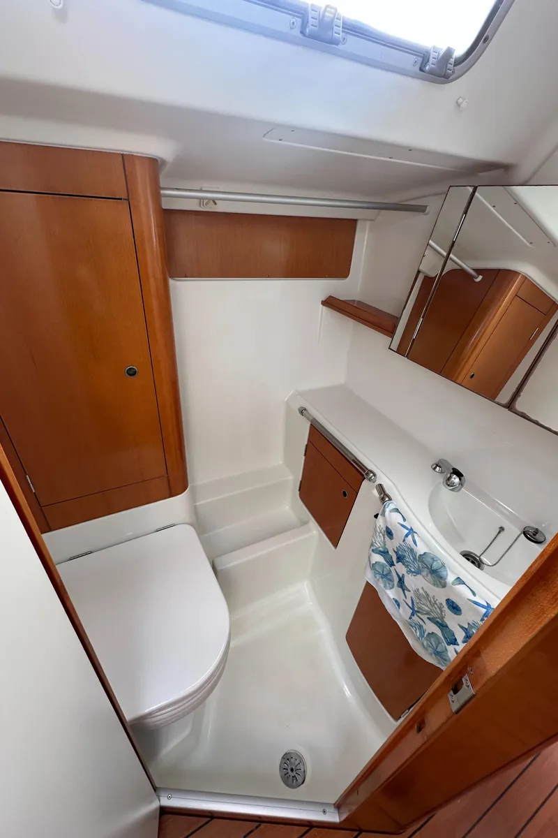 Slide: The Image of Compact bathroom in 2005 Beneteau First 44.7 yacht with wood accents and modern fixtures. - 21