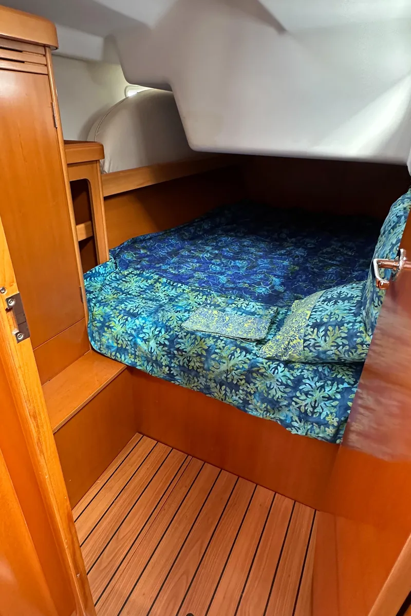 Slide: The Image of Cozy cabin interior of 2005 Beneteau First 44.7 sailboat with blue bedding. - 23