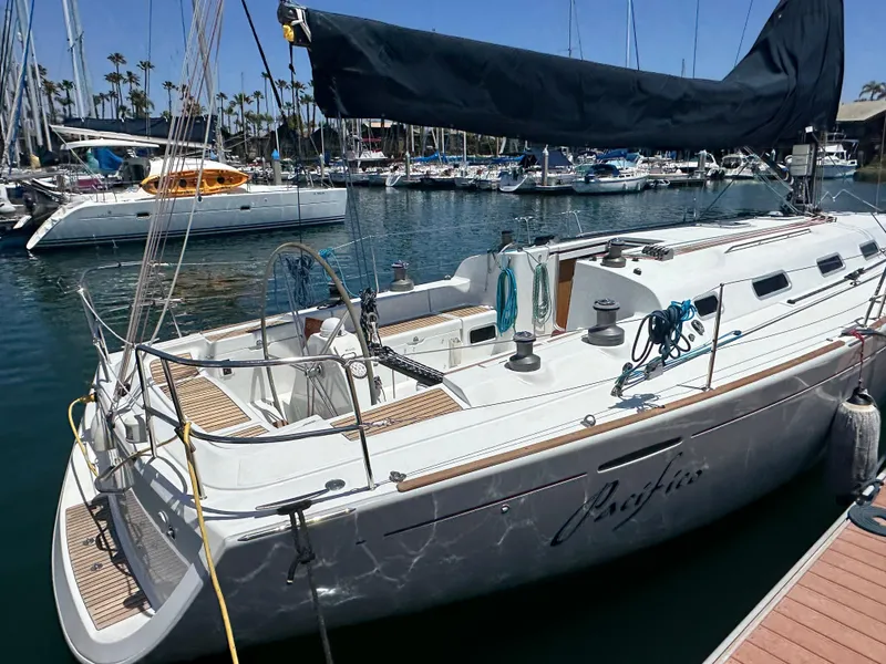 Slide: The Image of Beneteau First 44.7 sailboat, 2005 model, docked in a marina with other boats. - 3