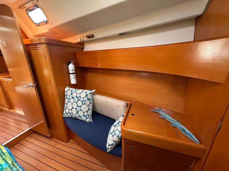 Slide: The Image of Interior of 2005 Beneteau First 44.7 yacht with wooden finish and cushioned seating. - 30