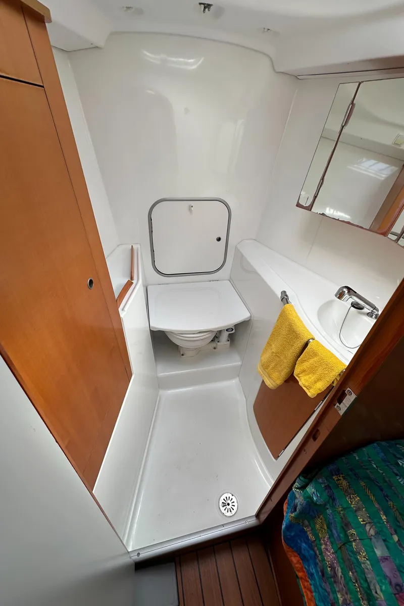 Slide: The Image of Beneteau First 44.7 2005 yacht bathroom with toilet, sink, and mirror. - 33