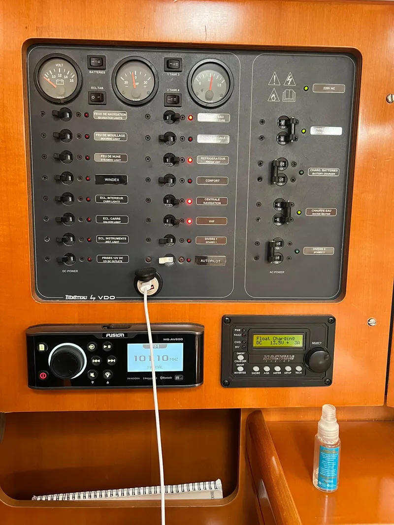 Slide: The Image of Control panel of a 2005 Beneteau First 44.7 sailboat with various switches and gauges. - 35