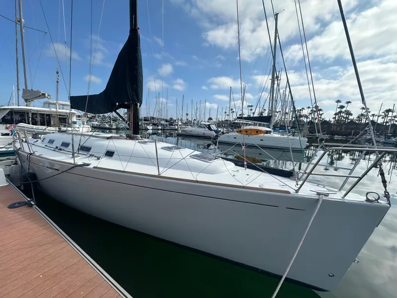 Slide: The Image of 2005 Beneteau First 44.7 sailboat docked in marina under blue sky. - 5