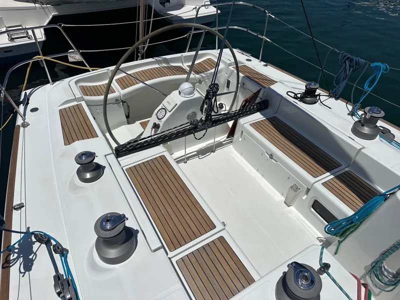 Slide: The Image of Cockpit of 2005 Beneteau First 44.7 sailboat with wooden seating and steering wheel. - 6