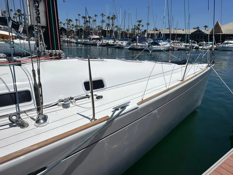 Slide: The Image of 2005 Beneteau First 44.7 sailboat docked in a marina, surrounded by other boats. - 7