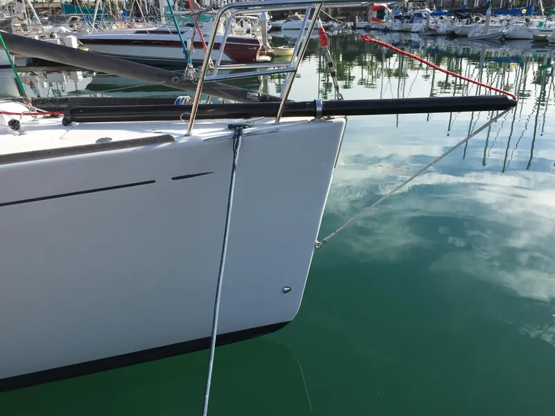 Slide: The Image of Sailboat Beneteau First 44.7, 2005 model, docked in a marina with calm waters. - 9