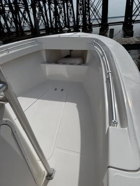 Slide: The Image of 2006 Angler 2600CC Limited Edition boat, white deck, docked near industrial structure. - 11