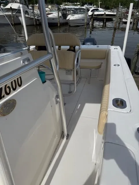 Slide: The Image of 2006 Angler 2600CC Limited Edition boat docked at marina, featuring seating and railing. - 13
