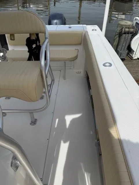 Slide: The Image of 2006 Angler 2600CC Limited Edition boat interior with beige seating and metal railings. - 14