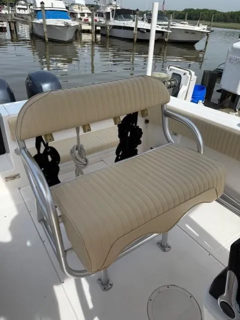 Slide: The Image of 2006 Angler 2600CC Limited Edition boat with beige seating at a marina. - 16