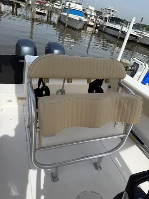 Slide: The Image of 2006 Angler 2600CC Limited Edition boat with dual engines at a marina. - 17