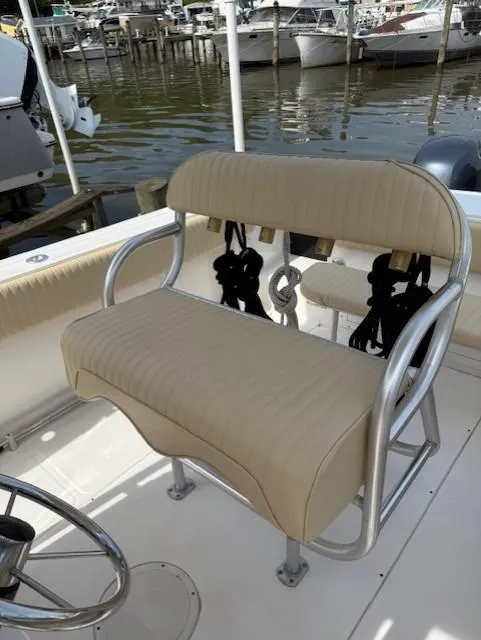Slide: The Image of 2006 Angler 2600CC Limited Edition boat seat with beige upholstery at a marina. - 18