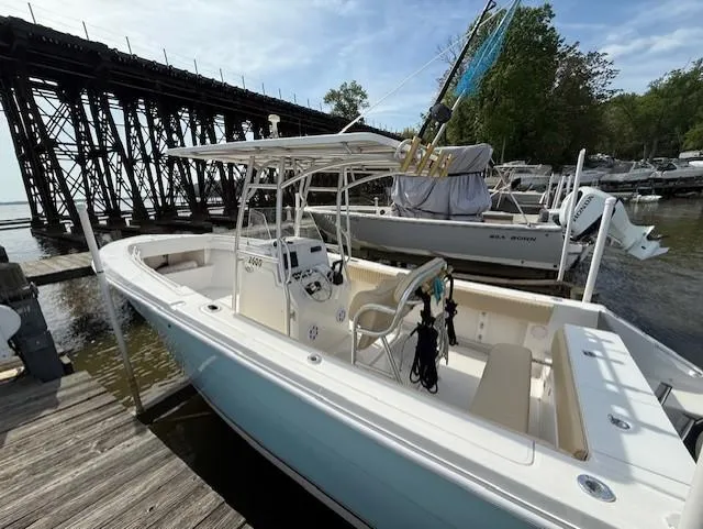 Slide: The Image of 2006 Angler 2600CC Limited Edition boat docked near wooden bridge. - 2
